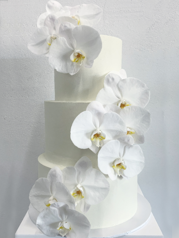 white buttercream cake with orchids